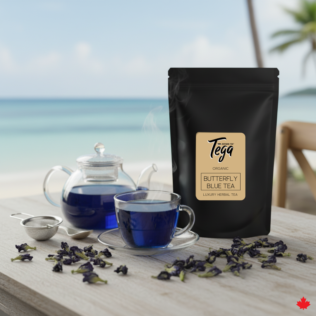 Tea packaging with a cup of tea and butterfly pea flowers on a table by a window with a view of water.