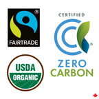 Four sustainability logos including Fairtrade, Zero Carbon, USDA Organic, and a logo with a blue circle and green leaf on a white background.