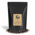 Black tea packaging with 'Tega' label on a white background