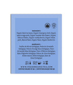 Back of a tea package with ingredient list and branding on a blue background