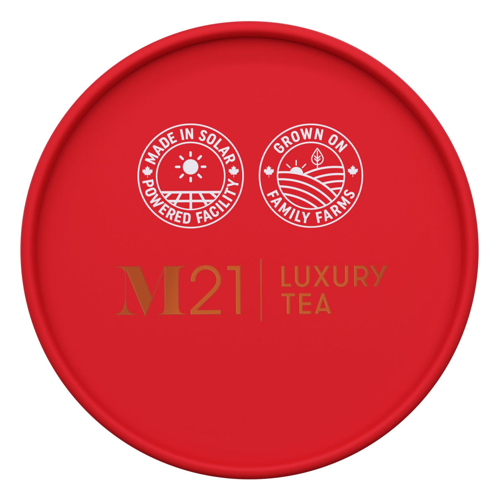 Red lid of M21 Luxury Tea packaging with sustainability logos on a white background