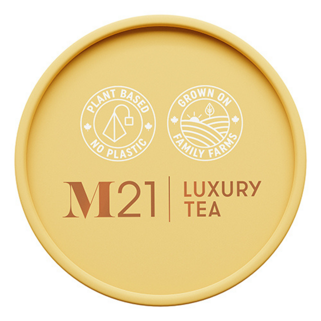 Round yellow container of M21 Luxury Tea with branding and sustainability claims on a white background