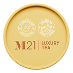 Round yellow container of M21 Luxury Tea with branding and sustainability claims on a white background