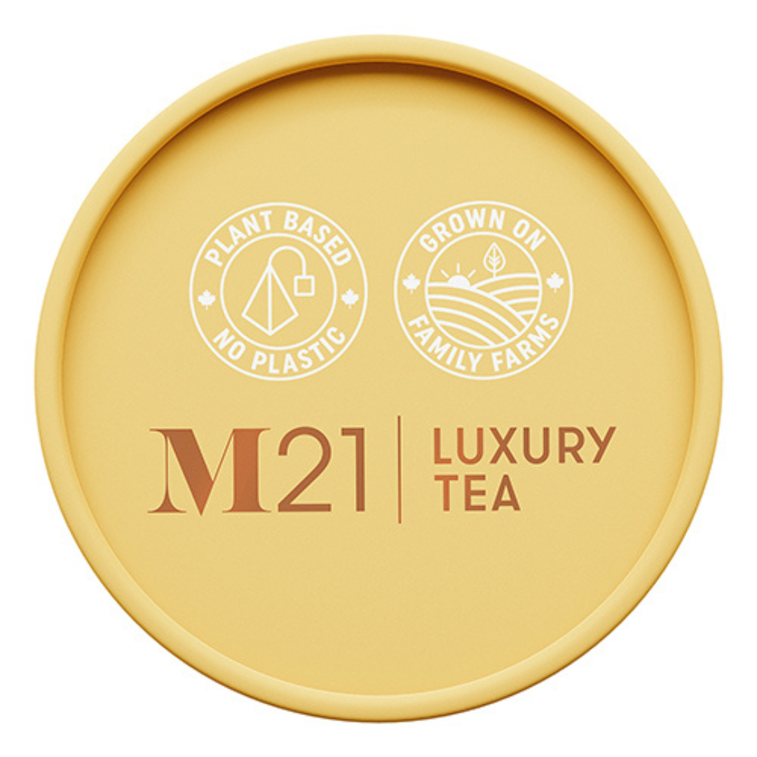 Round yellow container of M21 Luxury Tea with branding and sustainability claims on a white background