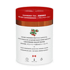 Tea canister with red lid and white body displaying cranberry tea branding.