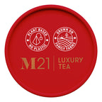 Red lid of M21 Luxury Tea packaging with branding and sustainability claims.