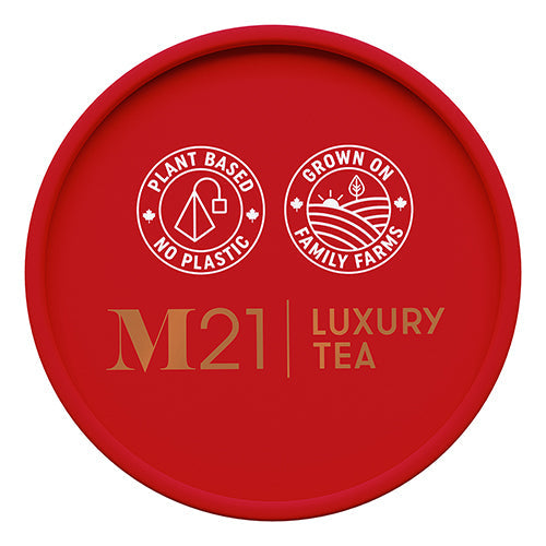 Red lid of M21 Luxury Tea packaging with branding and sustainability claims.