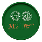 Green lid of M21 Luxury Tea packaging with branding and sustainability claims.