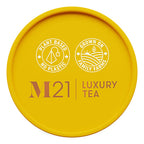Yellow lid of M21 Luxury Tea packaging with branding and sustainability claims.