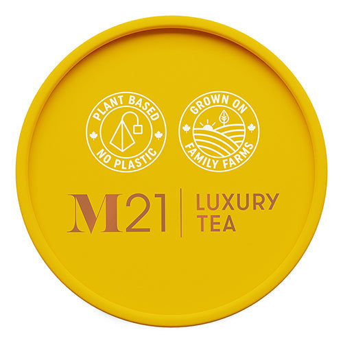 Yellow lid of M21 Luxury Tea packaging with branding and sustainability claims.