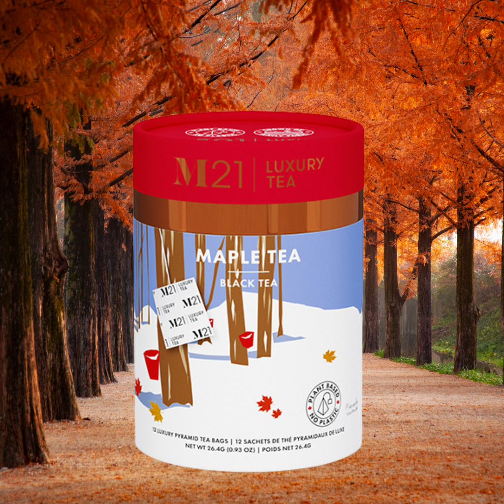 M21 Luxury Tea canister with a maple leaf design against an autumn forest background