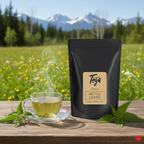 Tega Organic Nettle Leaves tea package with a cup of tea on a wooden table in a scenic outdoor setting.