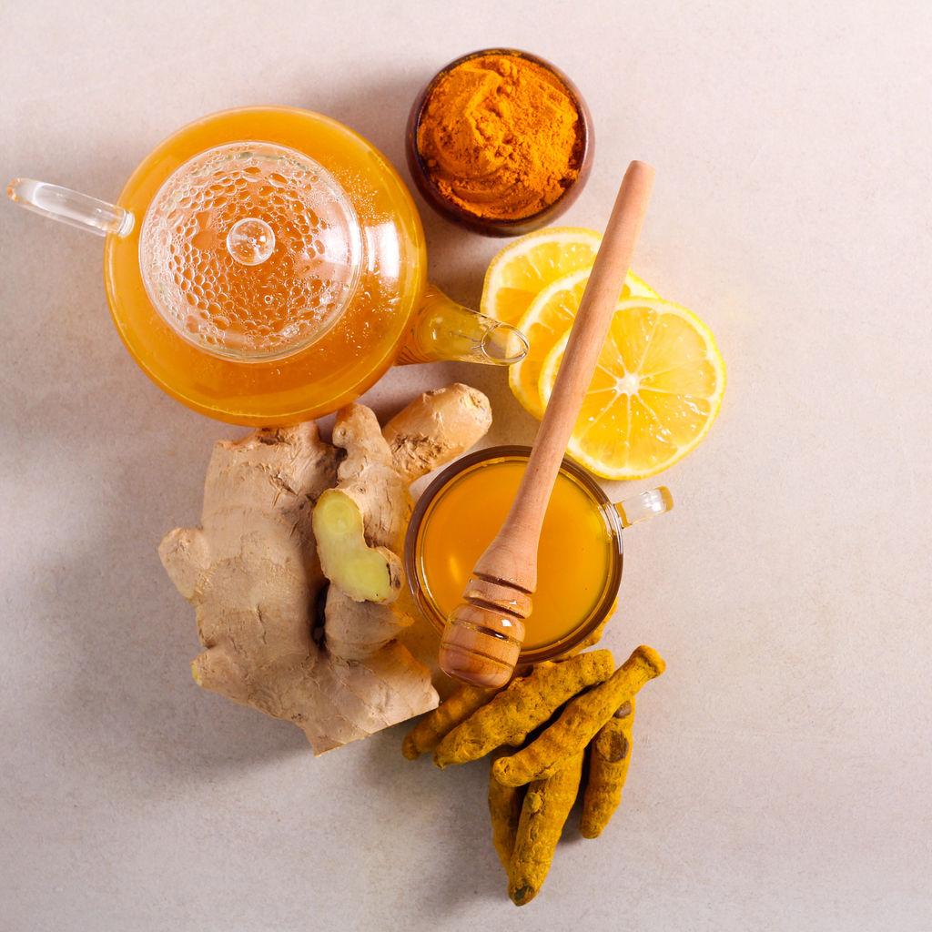 Tea with lemon, ginger, turmeric, and honey on a light background
