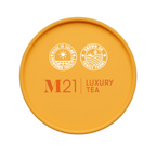 Yellow lid of M21 Luxury Tea packaging with branding and sustainability icons.