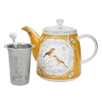 Yellow teapot with bird design and metal tea infuser on a white background