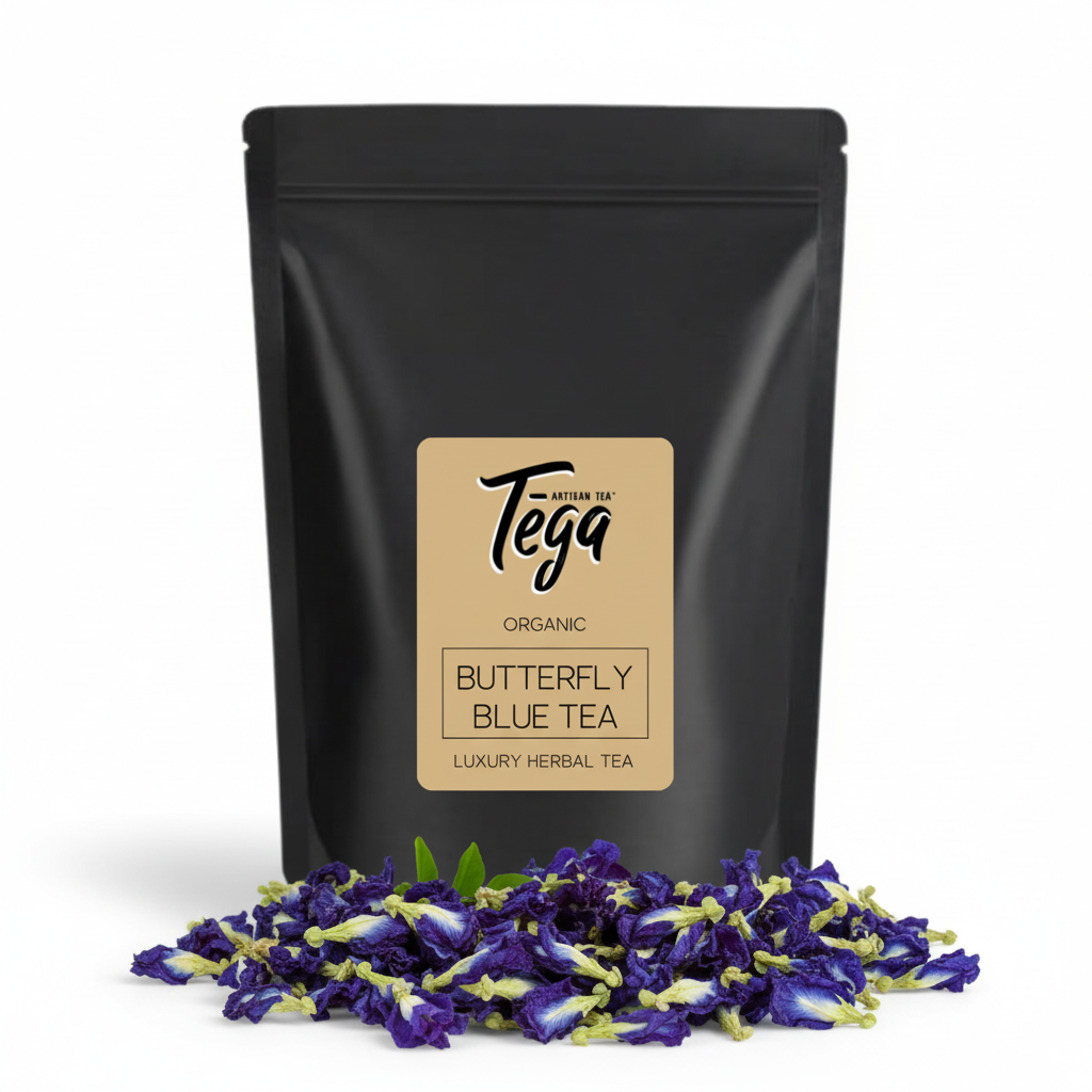 Black tea packaging with Tega label and butterfly pea flowers on a white background