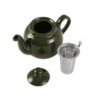 Green ceramic teapot with a metal filter on a white background