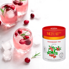 Cranberry tea with glasses of cranberry juice and M21 Cranberry Tea packaging on a white background