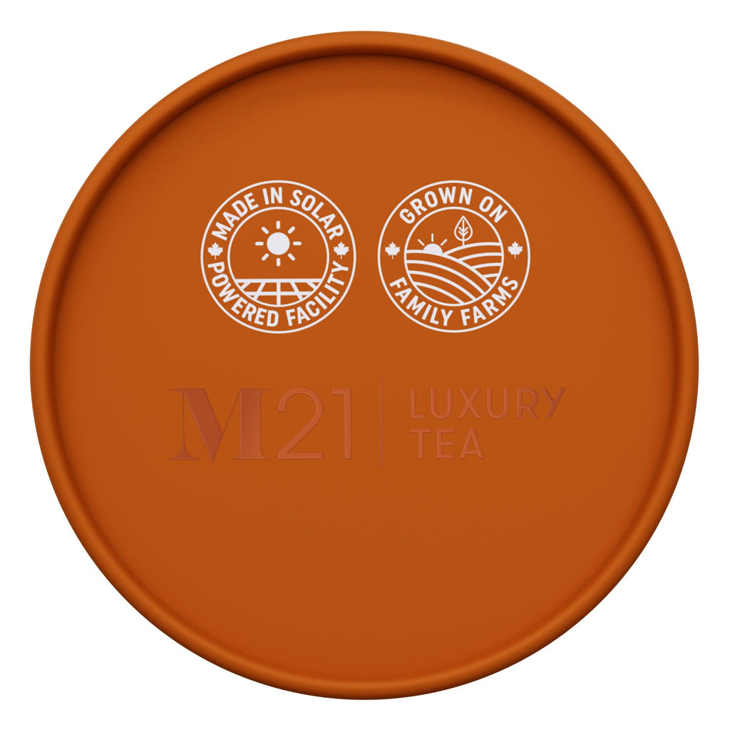 Orange lid with 'M21 Luxury Tea' branding and sustainability icons on a white background